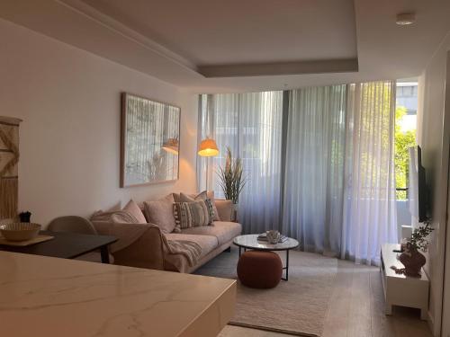 a living room with a couch and a table at Apartment in South Melbourne in Melbourne