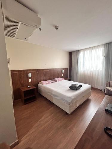 a bedroom with a bed and a wooden floor at 705. Flat hotel Go Inn in Brasilia