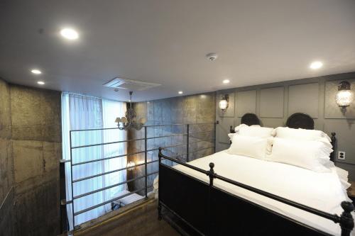 a bedroom with a large bed with white pillows at SS Resort in Gapyeong