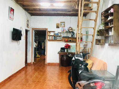 a living room with a motorcycle parked in it at RosiesHome in Da Lat