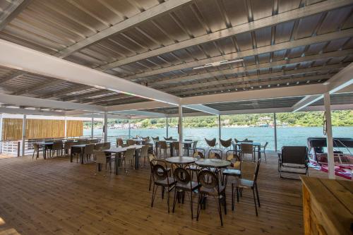 a dining area with tables and chairs on a boat at SS Resort in Gapyeong