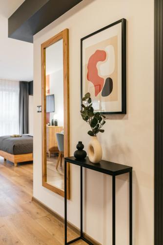 a living room with a table and a mirror at ORSO Rooms & Apartments - LoftAffair Collection in Warsaw