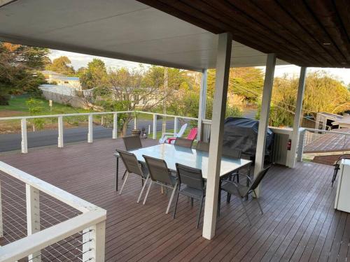 a patio with a table and chairs on a deck at Coastal Retreat, 400 Metres to beach in Cowes