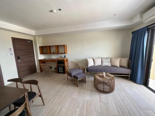 a living room with a couch and a table and chairs at Bluewater Maribago Beach Resort in Mactan