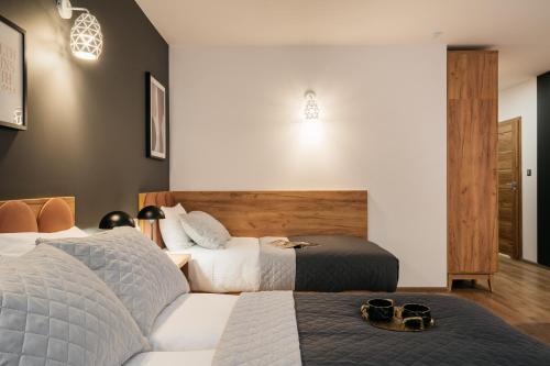 a hotel room with two beds with shoes on them at ORSO Rooms & Apartments - LoftAffair Collection in Warsaw