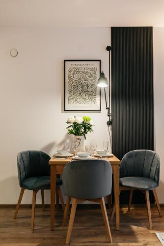 a dining room with a table and two chairs at ORSO Rooms & Apartments - LoftAffair Collection in Warsaw