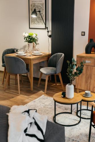a living room with a dining room table and chairs at ORSO Rooms & Apartments - LoftAffair Collection in Warsaw