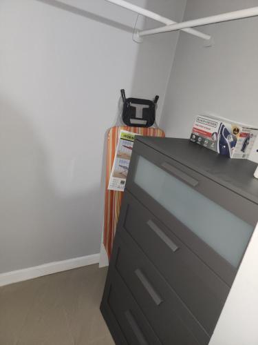 a black dresser in a corner of a room at Comfy and cozy in Kingston