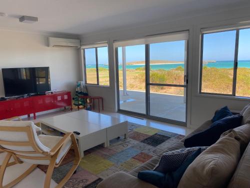 a living room with a view of the ocean at Ospreys View - Relaxed Coastal Vibe in Lancelin