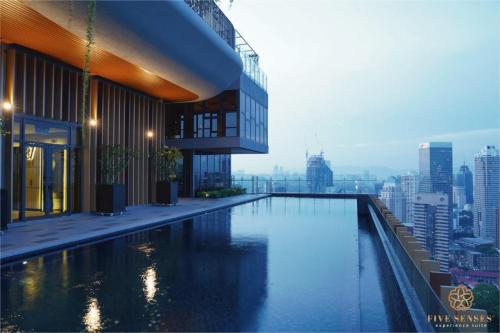 a swimming pool on top of a building with a city at Ceylonz Suite Kuala Lumpur Five Senses in Kuala Lumpur