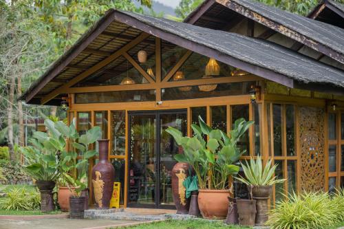 a building with plants in front of it at Daya Farm and Adventure in Banay-Banay