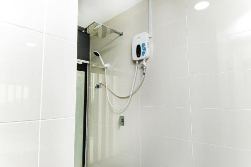 a shower with a shower head in a bathroom at Mosaic Southkey Marine Blue 2BR by Our Stay in Johor Bahru