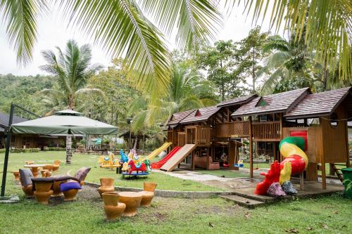 a resort with a playground with chairs and a slide at Daya Farm and Adventure in Banay-Banay