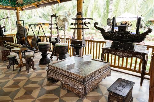a room filled with lots of antique furniture at Daya Farm and Adventure in Banay-Banay