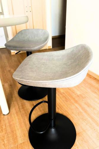 a chair and a table on a wooden floor at The Global West in Niihama