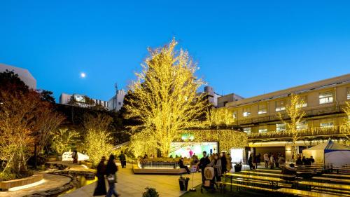 a group of people walking around a christmas tree at Hotel JAL City Fukuoka Tenjin in Fukuoka
