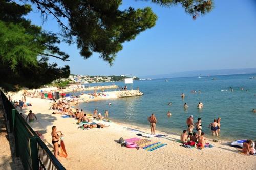 a group of people on a beach in the water at Guesthouse Mala Luce Stobreč in Split