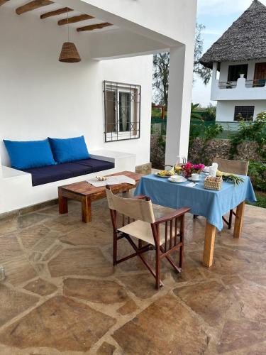 a living room with a table and a couch at Nyumbani Tamu in Watamu