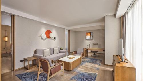 a living room with a couch and a table at Crowne Plaza Chengdu Wuhou by IHG in Chengdu