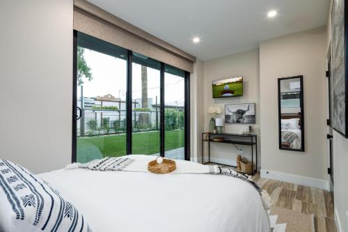 a bedroom with a large bed and a large window at Unbeatable Location, Heated Pool, Bbq, Misters in Chandler