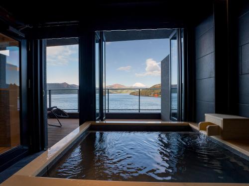 a swimming pool with a view of the water at Rakuten STAY FUJIMI TERRACE Hakone Ashinoko in Hakone