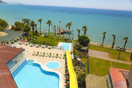 an aerial view of a resort with a pool and the ocean at Nagidos Hotel in Bozyazı