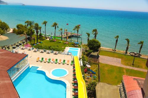 an aerial view of a resort with a pool and the ocean at Nagidos Hotel in Bozyazı