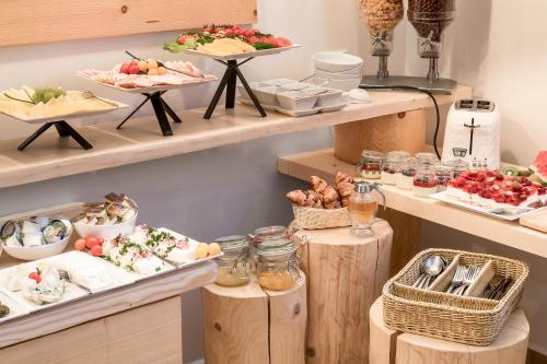 a buffet with plates of food on wooden shelves at Villa 11 Folk & Design in Zakopane