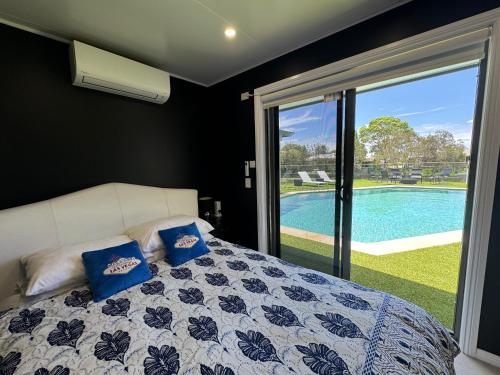 a bedroom with a bed and a view of a pool at Lakeside Retreat in Gold Coast