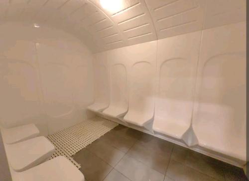 a bathroom with white walls and a white toilet at K AVENUE GC kk house in Kota Kinabalu