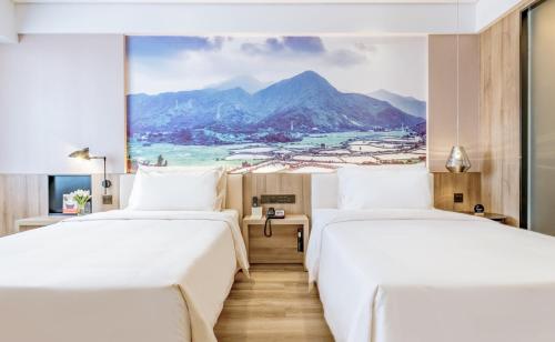 Ένα ή περισσότερα κρεβάτια σε δωμάτιο στο Atour Hotel Huizhou Huiyang High-speed Railway Station