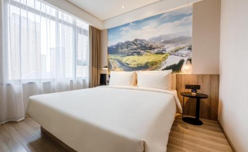 Ένα ή περισσότερα κρεβάτια σε δωμάτιο στο Atour Hotel Xi'an West Erhuan Road Tai'ao