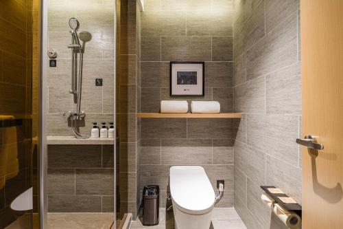a bathroom with a toilet and a shower at Atour Hotel Hangzhou Huanglong Wanke Xueyuan Road in Hangzhou