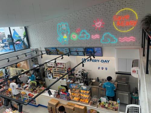 a grocery store with people standing in the counter at Room with PrivateBathroom, Projector, KSL Mall in Johor Bahru