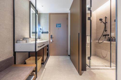 a bathroom with a sink and a shower at Atour Hotel Shenzhen Futian CBD Civic Center in Shenzhen