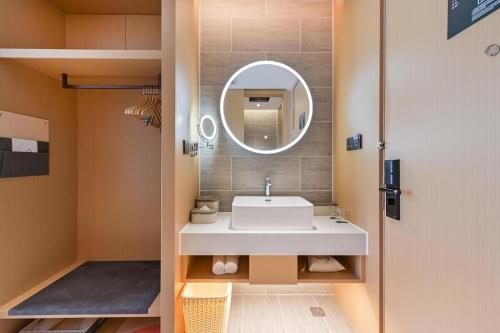 a bathroom with a sink and a mirror at Atour Hotel Beijing North Chaoyang Road Changyingtian Street in Beijing