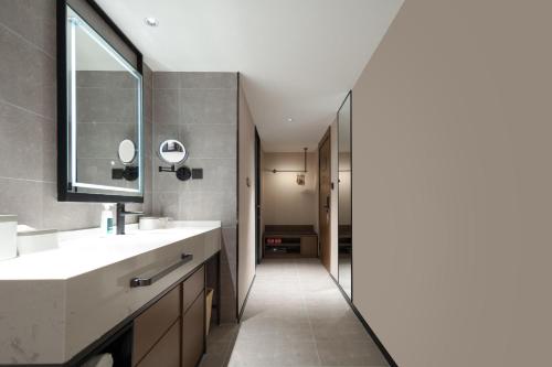 a bathroom with a sink and a mirror at Atour Hotel Shanghai Lujiazui South Pudong Road in Shanghai