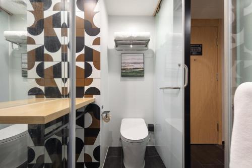 a small bathroom with a toilet and a sink at Atour X Hotel Shanghai Xujiahui Sports Center in Shanghai
