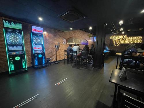 a restaurant with people sitting at tables in a room with video games at Room with PrivateBathroom, Projector, KSL Mall in Johor Bahru