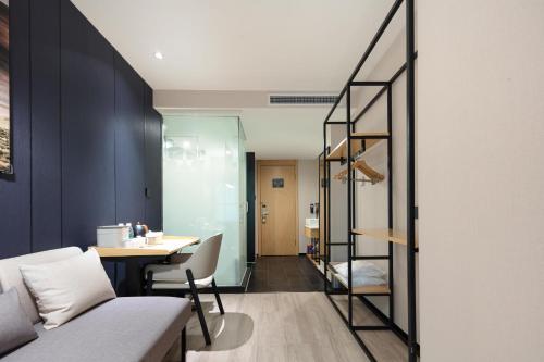 a room with a table and a staircase in it at Atour X Hotel Shanghai Xujiahui Sports Center in Shanghai