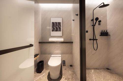 a bathroom with a toilet and a shower at Atour S Hotel Shenzhen Luohu Clams in Shenzhen