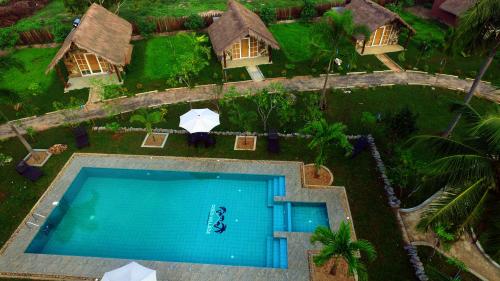 an overhead view of a swimming pool in a resort at Coco Village Hotel Chilaw in Chilaw