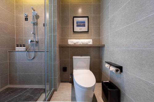a bathroom with a toilet and a shower at Atour Hotel Kunming South High Speed ​​Railway Station University Town in Kunming