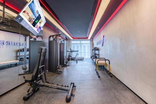 a gym with treadmills and exercise equipment in a room at Atour S Hotel Beijing Daxing International Airport in Daxing
