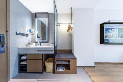 a bathroom with a sink and a mirror at Atour Hotel Kunming Yunnan-Burma Avenue in Kunming