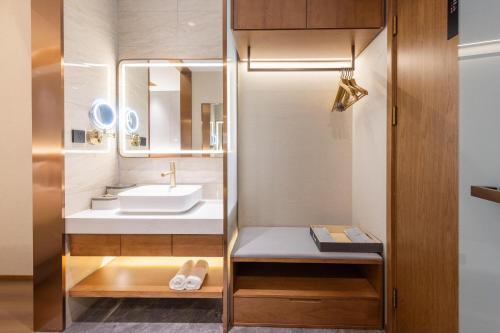 a bathroom with a sink and a mirror at Atour X Hotel Beijing Haidian Sijiqing in Beijing