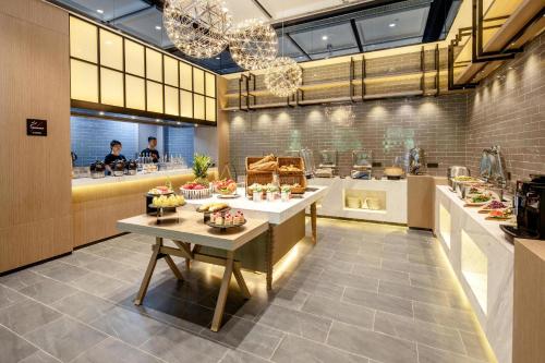 a kitchen with a table with food on it at Atour Hotel Xi'an West Erhuan Road Tai'ao in Xi'an