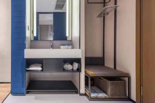 廣州的住宿－广州琶洲会展广州塔地铁站轻居酒店，一间带水槽和镜子的浴室