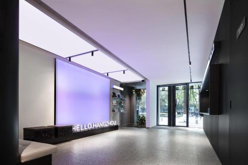 a hallway of a building with a sign on the wall at Atour Light Hotel Hangzhou West Lake Lakeside Pedestrian Street in Hangzhou