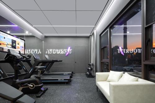 a living room with a couch and a gym at Atour Hotel Xiamen Xiang'an Torch Industrial Park in Xiang'an